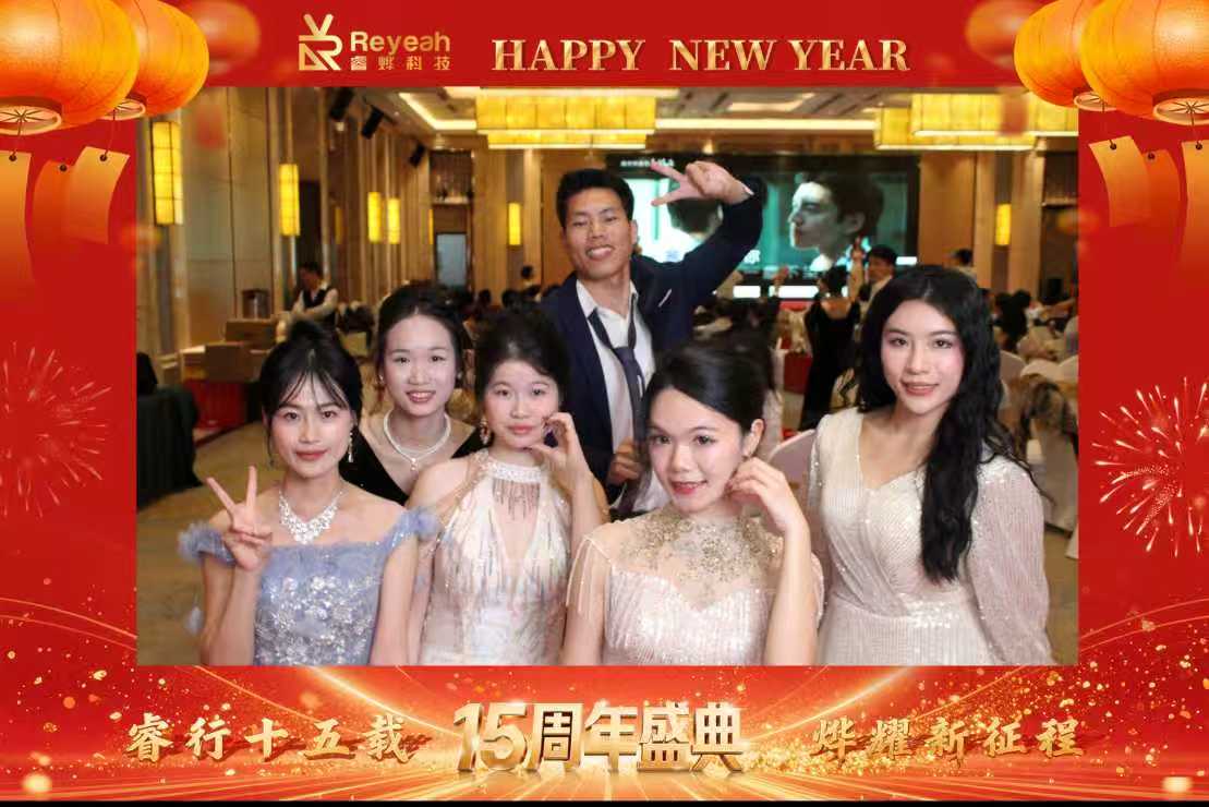 PhoPrint team members posing and smiling around the payment portable photo booth at their 15th-anniversary annual summit event.