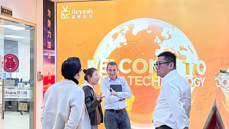 Nayax CCO Oren Tepper and PhoPrint CEO discussing strategy in front of a photo booth product wall